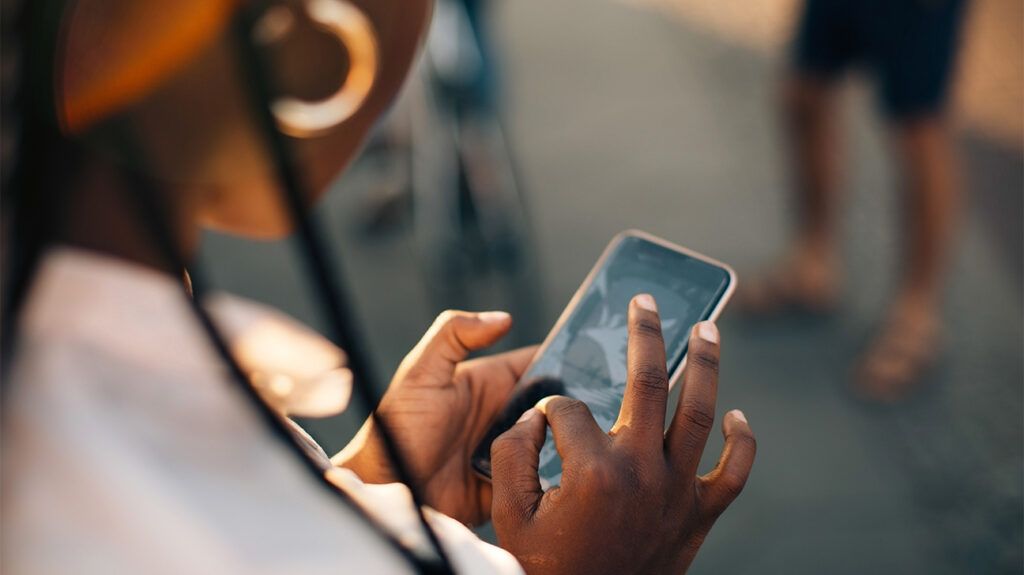 woman looking at smartphone screen