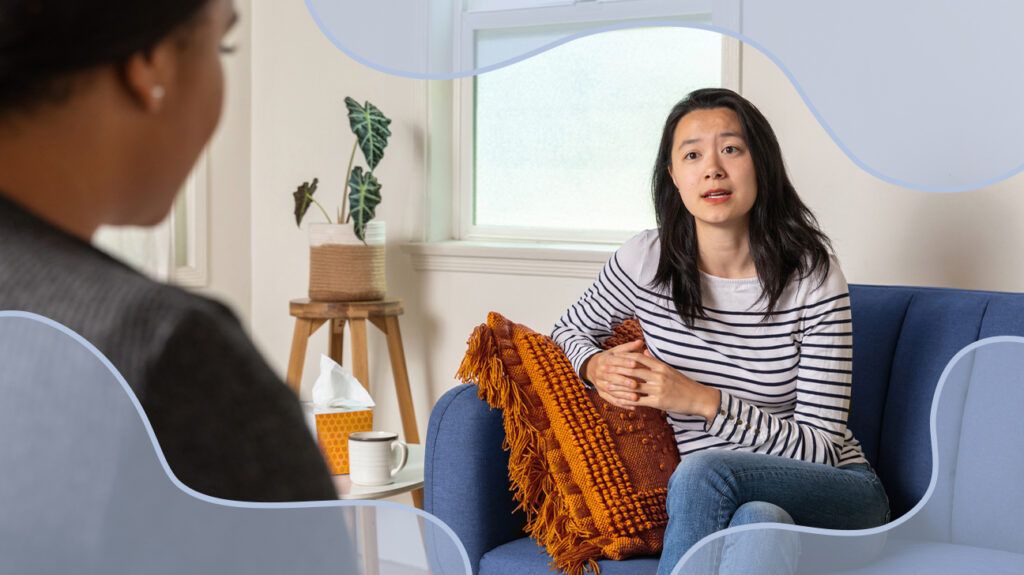 A woman talking to a female therapist in an office